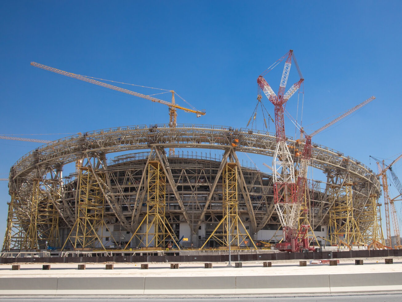 construction-side-of-a-football-stadium-with-cranes-and-scaffoldings
